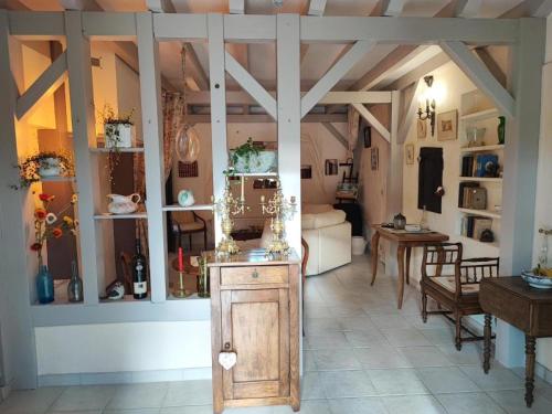a living room with a room with a table and a room with a room at La Demeure de la Vendémière in Pont-Melvez