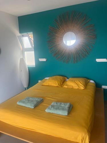 a bedroom with a large yellow bed with a blue wall at Casa Branca in Ponta do Sol