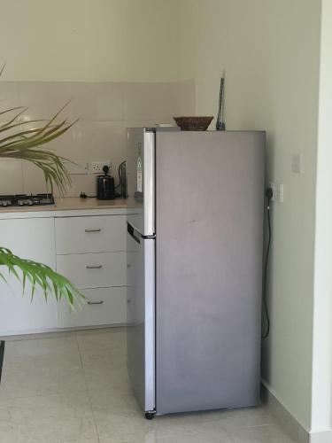 a stainless steel refrigerator in a kitchen at Sunset View Self Catering in Anse Boileau