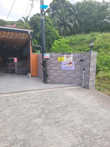 a brick wall with signs on it next to a building at Sunset View Self Catering in Anse Boileau