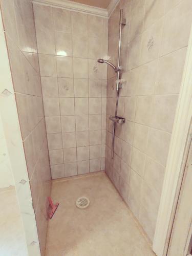 a shower stall with a drain in a bathroom at Lottefors Logi in Bollnäs
