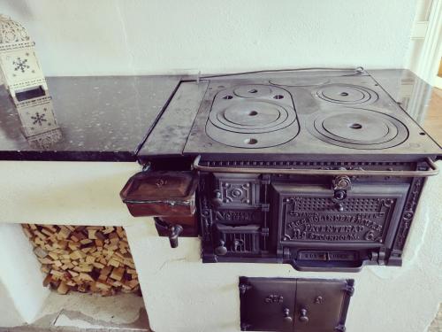 a black stove sitting on top of a wall at Lottefors Logi in Bollnäs