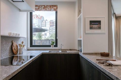 a kitchen with a sink and a window at Huswell - Luxury Villa for 8 Guests Near the Beach in Knokke in Knokke-Heist