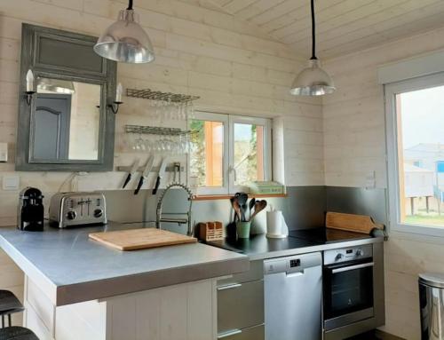 a kitchen with a counter top and some lights at CHALET la Perle de Gruissan in Gruissan