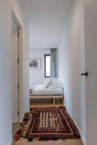 a bedroom with a bed and a rug on the floor at Huswell - Luxury Villa for 8 Guests Near the Beach in Knokke in Knokke-Heist