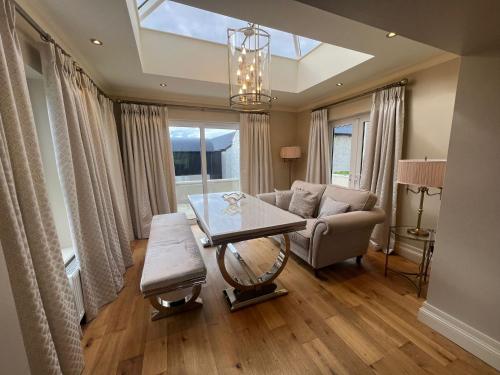 a living room with a table and a couch at Ballyness Lodge in Derry Londonderry