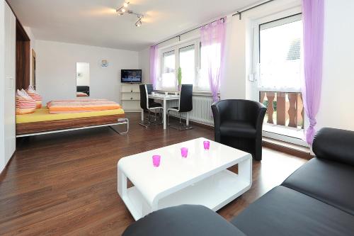 a living room with a couch and a table at Haus Hafenromantik in Neuharlingersiel