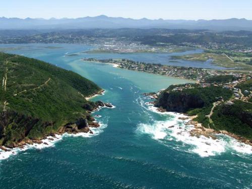 an aerial view of a river with a city at Isola Bella Guest House in Knysna