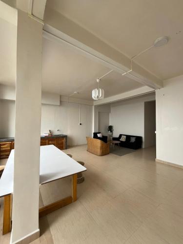 a large living room with a couch and a table at The Local Guest House in Āīzawl