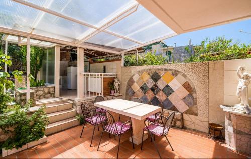 an outdoor patio with a table and chairs at Cozy Apartment In Zaton Veliki in Zaton