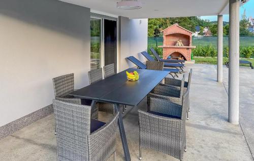a dining room table and chairs with a fireplace at Lovely Home In Krapinske Toplice in Krapinske Toplice