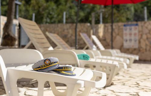 a group of chairs with hats sitting on them at Amazing Apartment In Stinica in Stinica