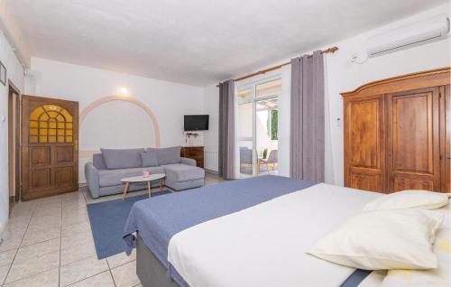 a bedroom with a large bed and a couch at Amazing Apartment In Stinica in Stinica