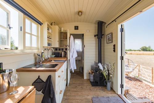 an interior view of a kitchen in a tiny house at The Romney by Bloom Stays in Ashford
