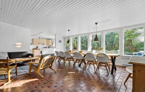 a kitchen and dining room with a table and chairs at 3 Bedroom Stunning Home In Skjern in Skjern