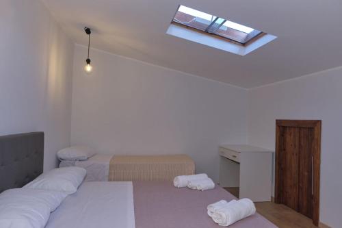 a bedroom with two beds and a window at Il sospiro B&B in Spinoso