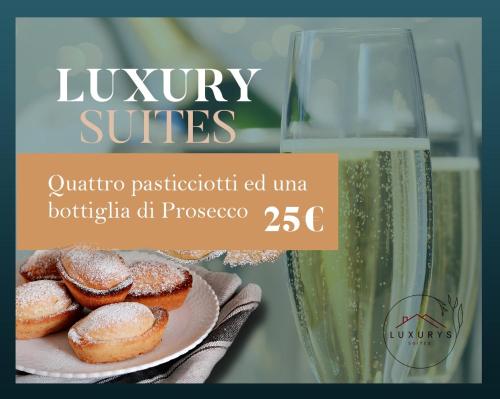 a bottle of wine and a plate of donuts and a glass at Suite Donna Filomena in Mesagne