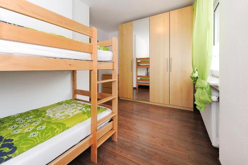 a small room with bunk beds and a hallway at Haus Hafenromantik in Neuharlingersiel