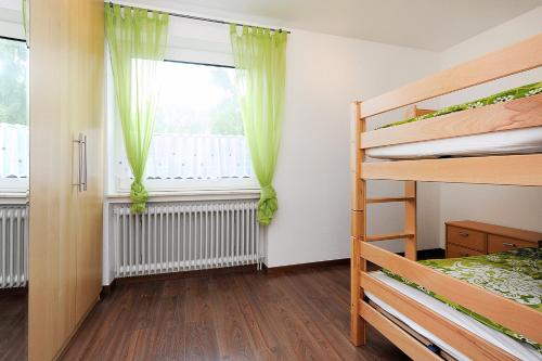 a bedroom with a bunk bed and a window at Haus Hafenromantik in Neuharlingersiel