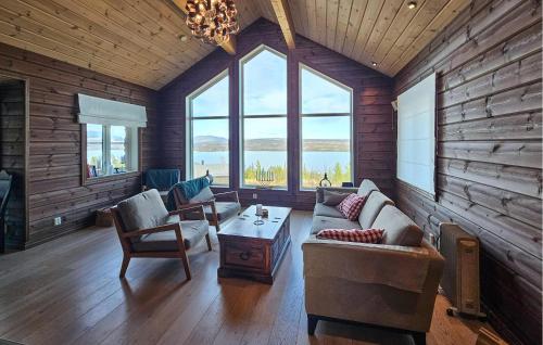 a living room with a couch and chairs and windows at Gorgeous Home In Gol With Sauna in Gol