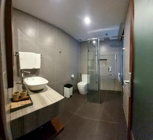 a bathroom with a toilet and a sink and a shower at Anh Nguyen Oceanfront Luxury Villas Nha Trang in Nha Trang