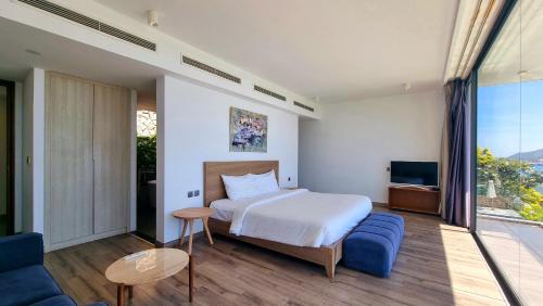 a bedroom with a bed and a large window at Anh Nguyen Oceanfront Luxury Villas Nha Trang in Nha Trang