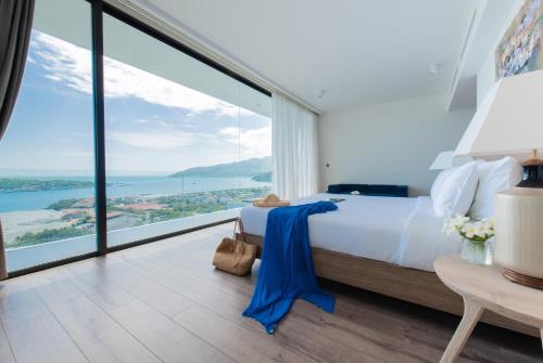 a bedroom with a bed and a large window at Anh Nguyen Oceanfront Luxury Villas Nha Trang in Nha Trang
