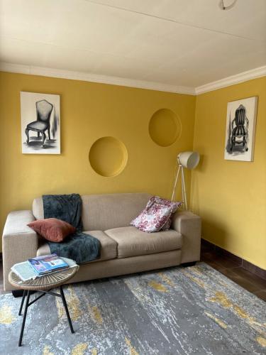 a living room with a couch and a table at Lulus bistro in Middelburg