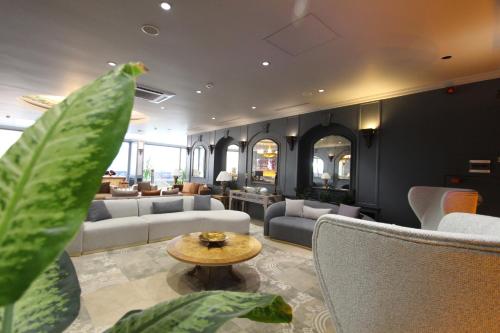a living room with couches and a table at Funda Hotel in Trabzon