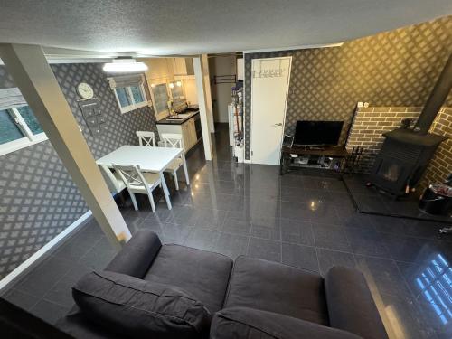 sala de estar con sofá, mesa y fogones en TaoTechHOUSE, en Hakuba