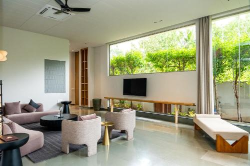 a living room with a couch and a tv at ORO The Estates, Nandi Hills in Nandigunda