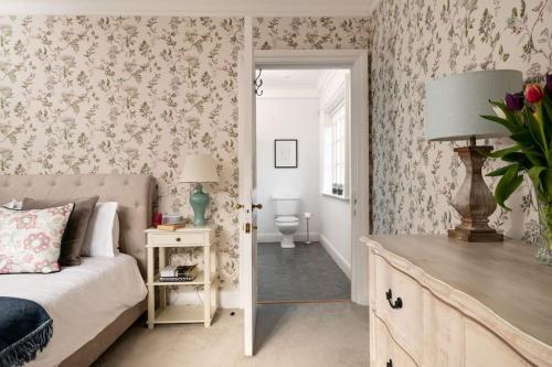 ein Schlafzimmer mit einem Bett und einem WC in einem Zimmer in der Unterkunft Gresham Hall - Norfolk Cottage Agency in Norwich
