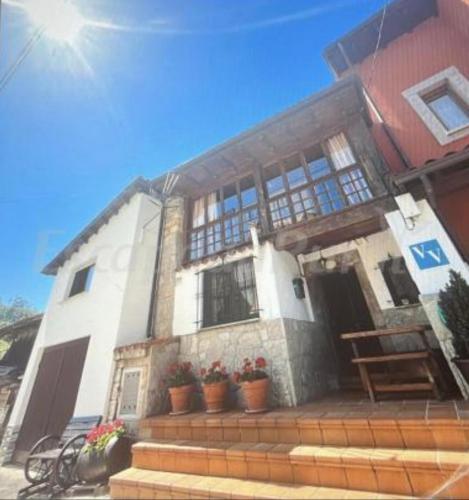 a house with potted plants in front of it at La casina de la Texa in La Sestal