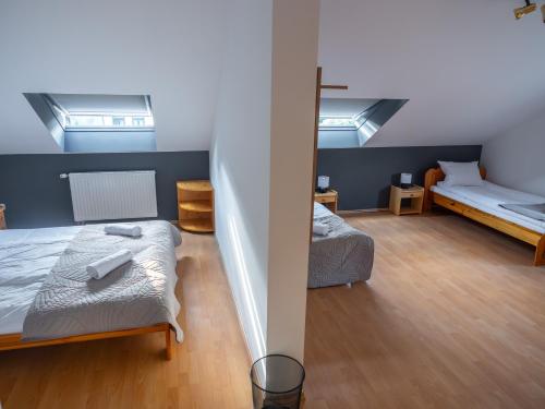 a bedroom with two beds and a bunk bed at Vitrin Panzió in Nagymaros