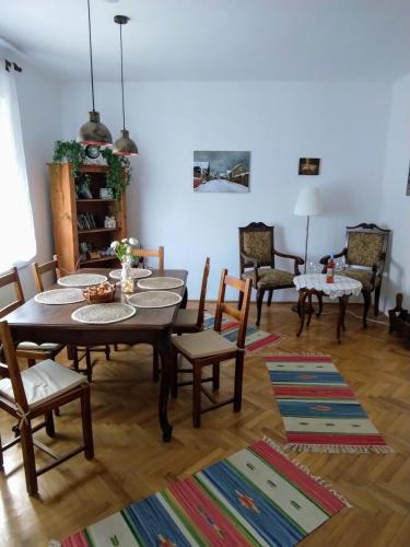 a dining room with a table and chairs at Sziget Gyöngye Vendégház in Tahitótfalu