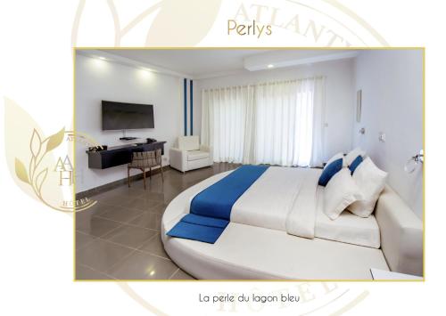 a bedroom with a large bed and a desk at Hotel l'ATLANTYS in Yopougon-Attié