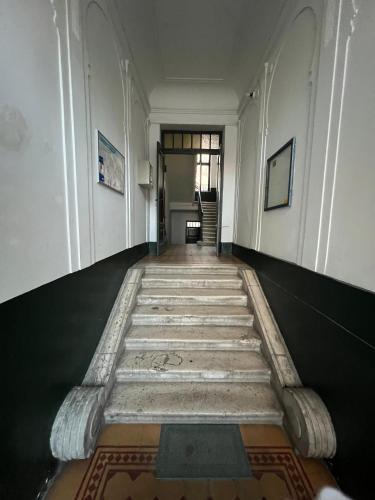 a hallway of a building with a rug on the floor at Waterfall Hostel in Sarajevo