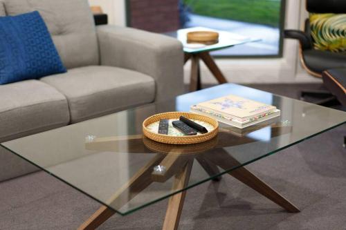 a living room with a glass table and a couch at Relaxing 3bd in tranquil setting in Bendigo