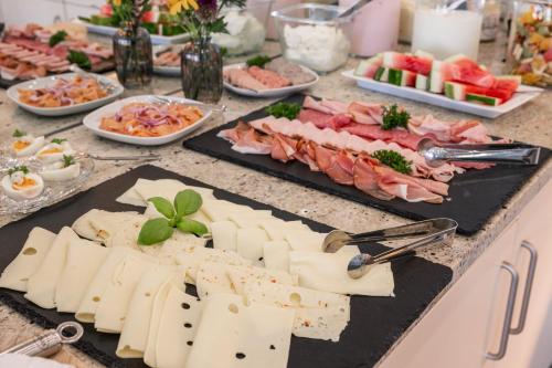 a buffet of cheese and meats on a table at Inselhotel Rügen in Göhren