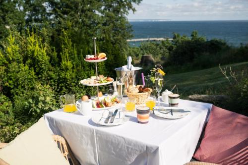 a white table with food and drinks on it at Inselhotel Rügen in Göhren
