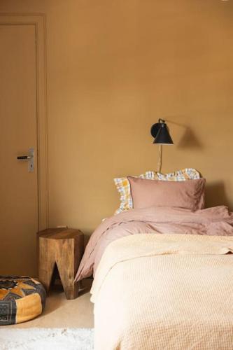 a bedroom with a bed with a lamp on it at Etagevåning på Stora torget in Visby