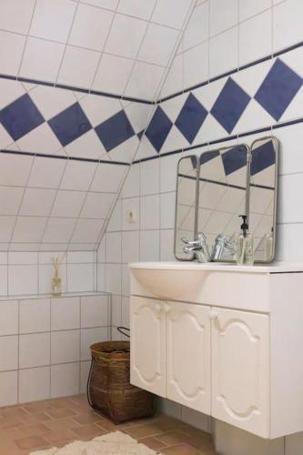 a bathroom with a sink and a mirror at Etagevåning på Stora torget in Visby