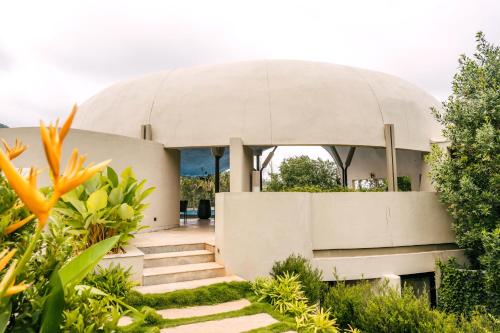 a house with a domed roof with stairs leading to it at ORO The Estates, Nandi Hills in Nandigunda