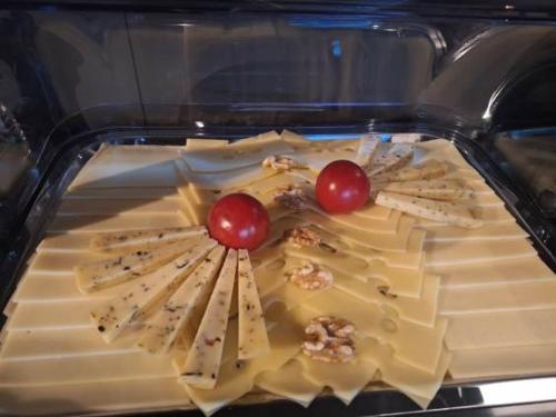a plastic container of food with cherries on top at Boutique & Wellness Hotel Vital in Moravske Toplice