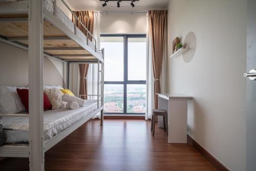 a bedroom with a bunk bed with a desk and a window at Setia Alam Convention Centre 3 Bedroom 2-9Pax #33 in Shah Alam