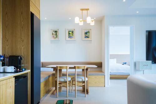 a kitchen and dining room with a table and chairs at Gran Hotel in Gunsan