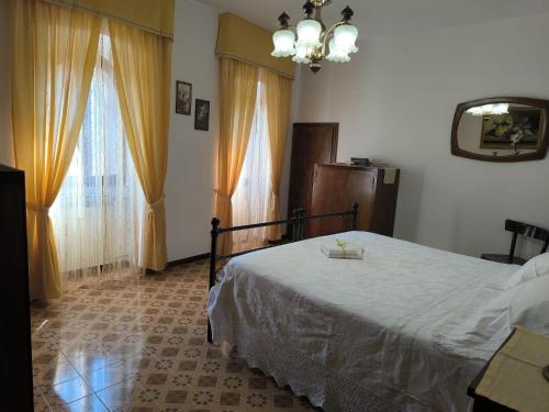 a bedroom with a bed and a large window at La Casa Dei Nonni in Gubbio