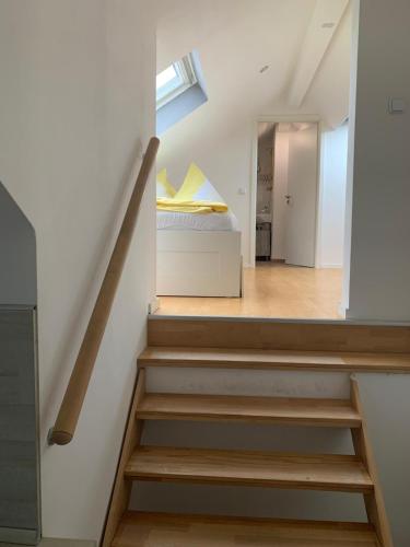 a staircase leading to a bedroom with a bed at Fewo Meschede Eversberg Radring in Meschede