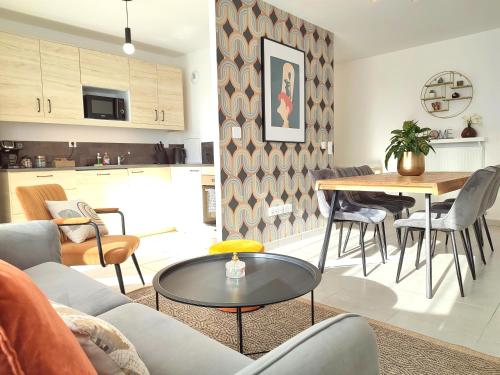 un salon avec une table et une cuisine dans l'établissement Disney Ratatouille Paris 5mn park & Val d'Europe, à Chessy