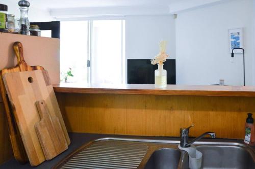 a kitchen with a sink and a counter with a knife at Sydney City Center Apartment with Free Parking in Sydney